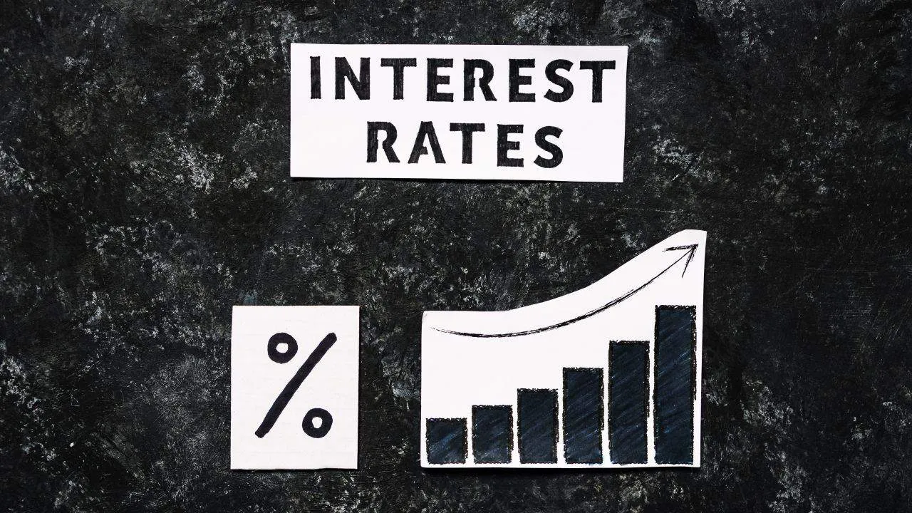 A graphics showing a percent and a graph with overlay text "interest rates"
