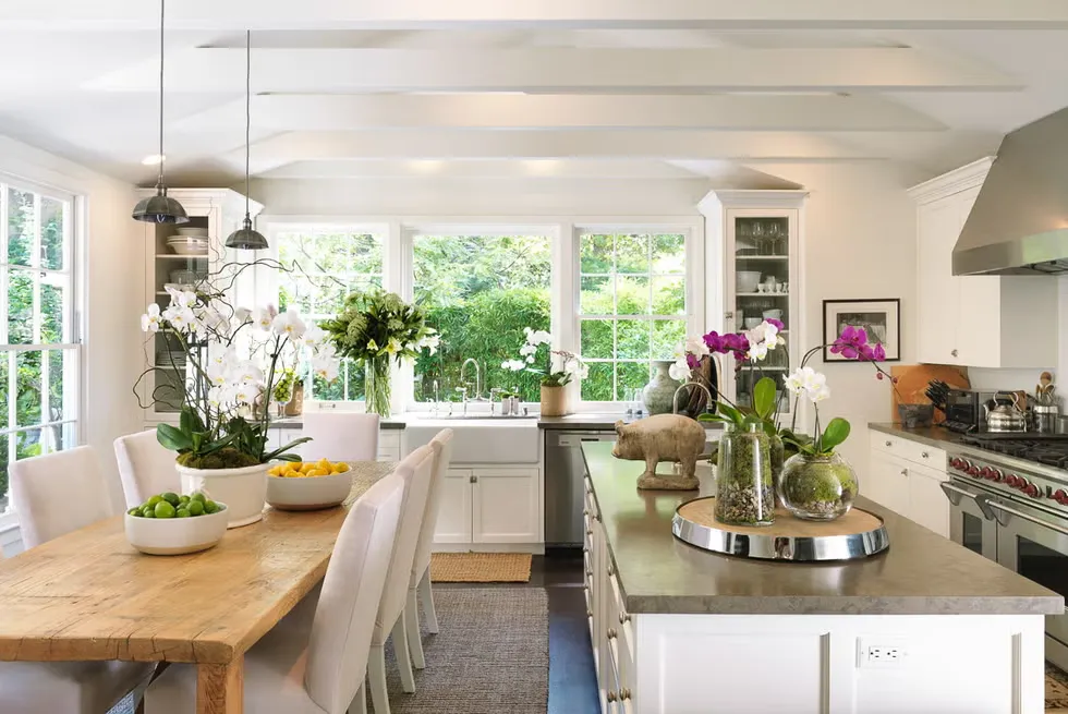 Modern luxury kitchen in Southern California with a large island, stainless steel appliances, and flowers.