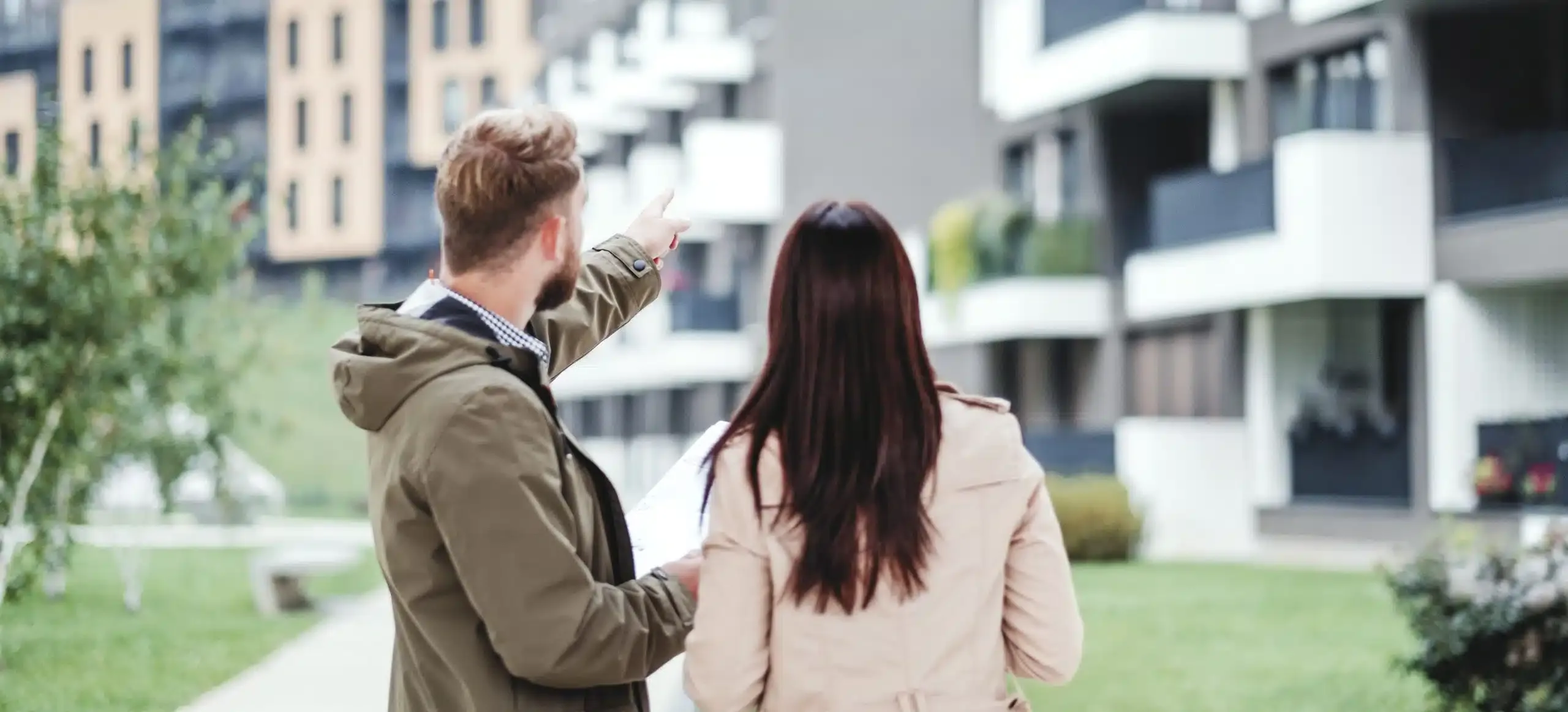 Back view of a couple viewing a modern luxury apartment in Southern California.