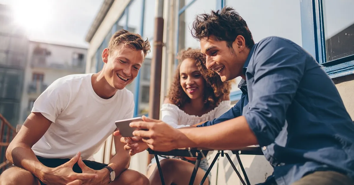 Three people watching on the phone.